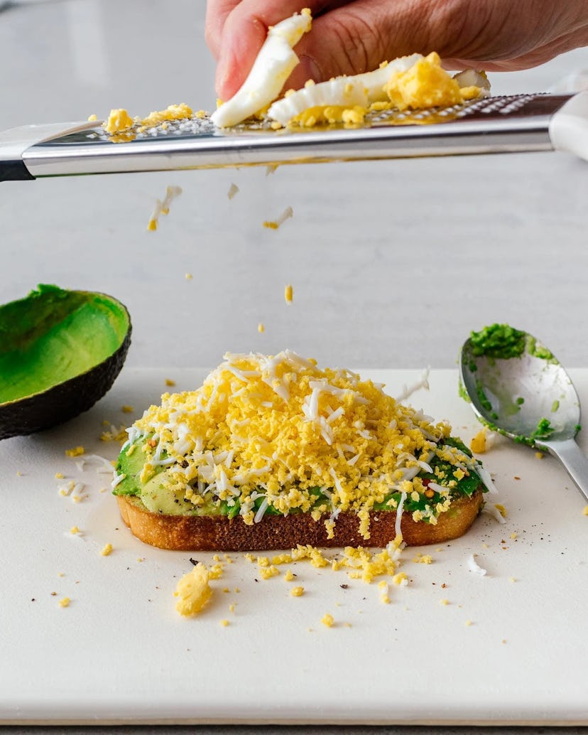 Grated egg avocado toast, in a story about boiled egg recipes to use up Easter eggs.