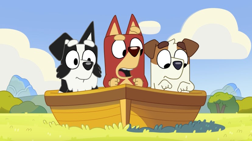 Mackenzie, Rusty, and Jack stand in a boat.