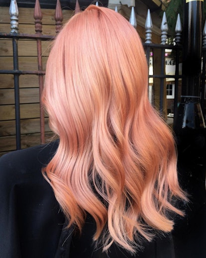 Peach fuzz hair colors are trending for summer 2024.