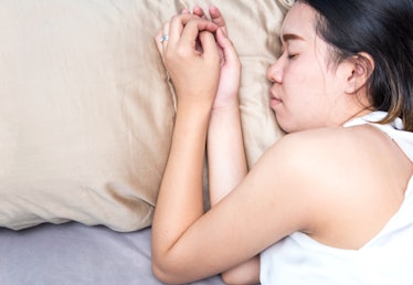 A woman sleeps on a silk pillowcase.