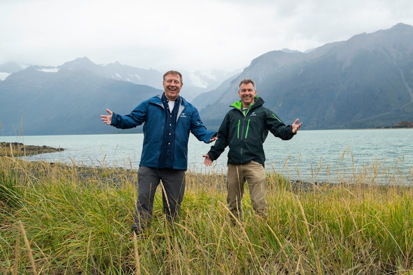 Martin and Chris Kratt stand before a misty mountain.