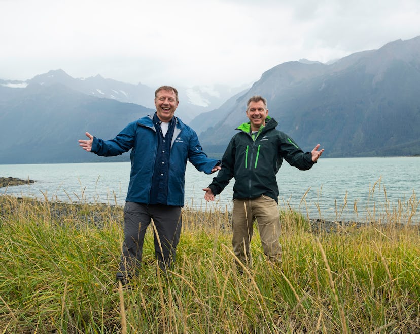 Martin and Chris Kratt stand before a misty mountain.