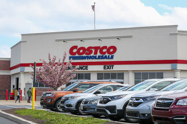 People shop at Costco on a spring day.