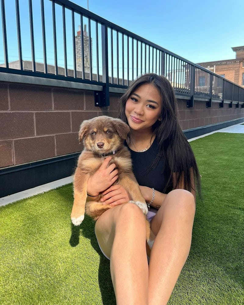suni lee cuddling with a puppy