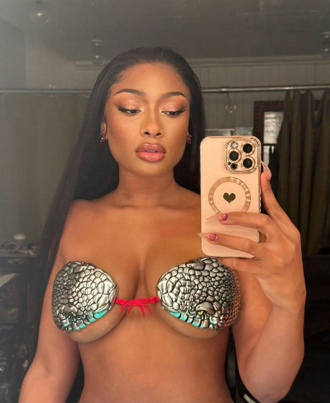 Megan Thee Stallion's black bob haircut and rhinestone tattoos are such a serve.