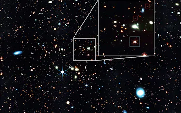 image of a field of stars and galaxies in space, with a section zoomed in two show two very faint ga...