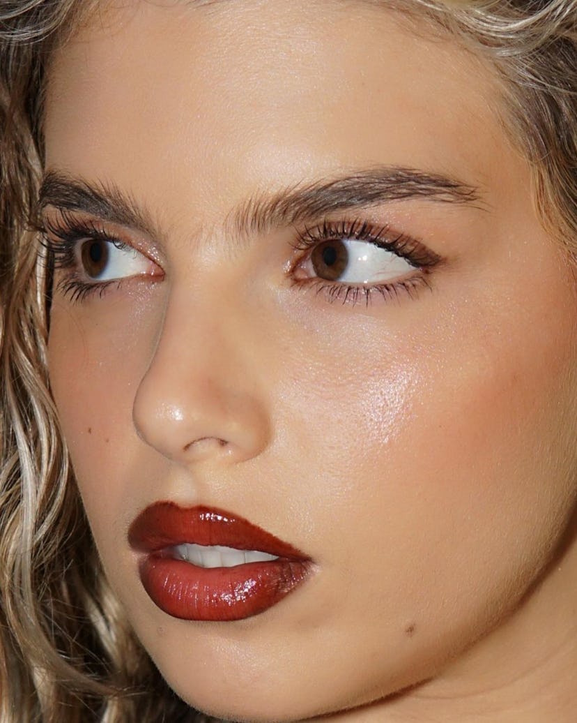 Red glossy lips are on-trend for spring 2024.
