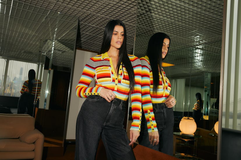 Gabriella Khalil stands against a mirrored wall.
