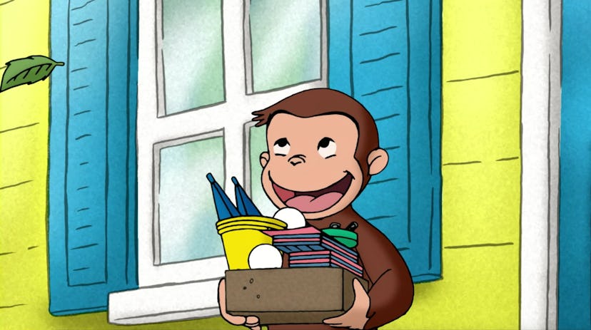 Curious George walks outside with arms full of toys.