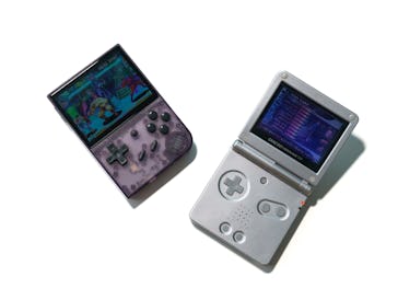 An Anbernic RG35XX retro handheld capable of playing Nintendo and PlayStation ROMS next to a Game Bo...