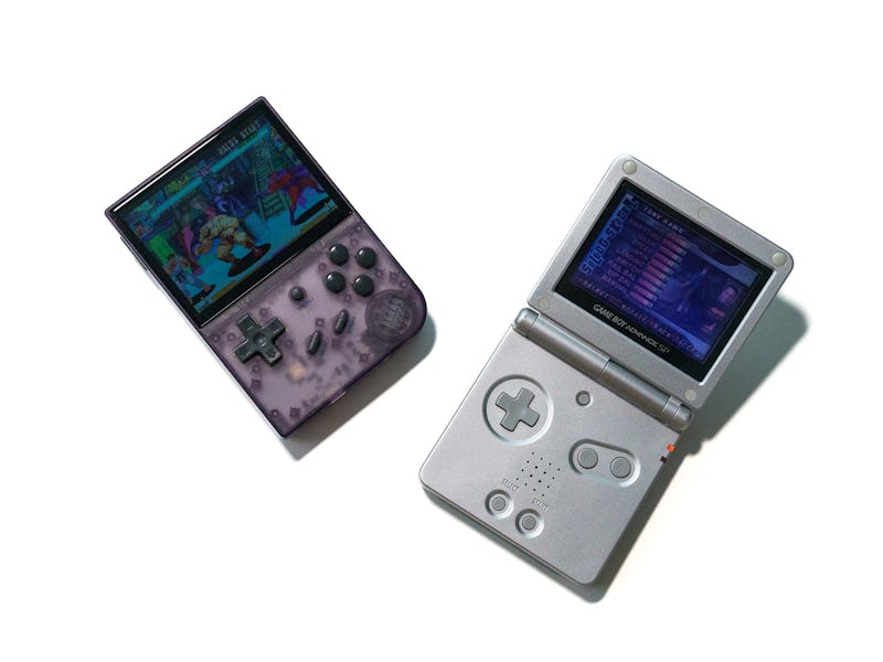 An Anbernic RG35XX retro handheld capable of playing Nintendo and PlayStation ROMS next to a Game Bo...
