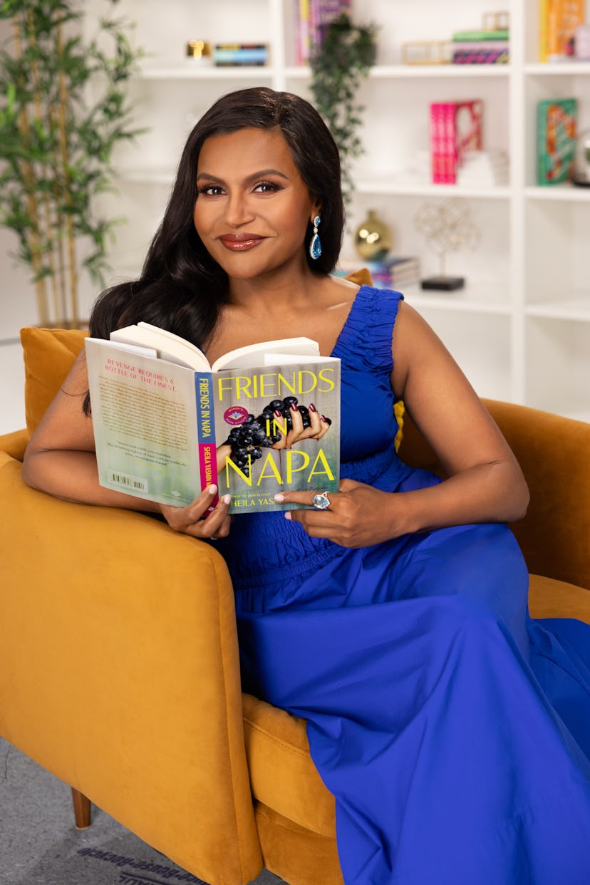 Mindy Kaling poses with the book 'Friends in Napa,' by author Sheila Yasmin Marikar.