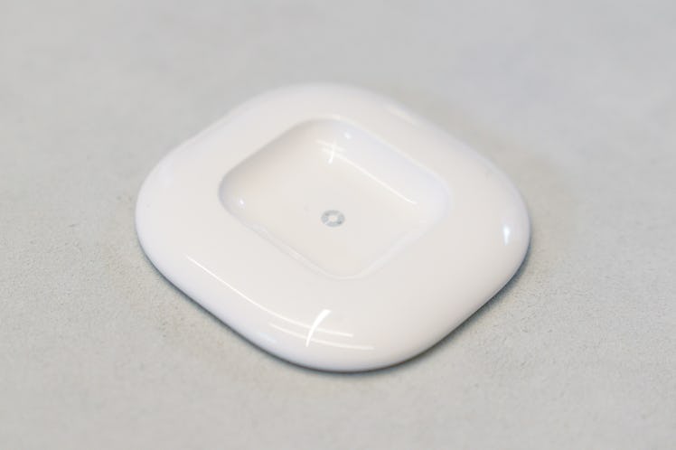 The Ai Pin’s Charge Pad wireless charges the device with an attached Battery Booster. It’s also used...