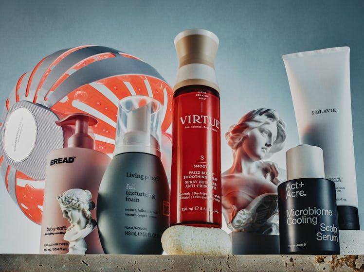 Assortment of hair care products from various brands displayed against a textured backdrop.