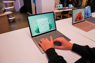 Scrolling on a green Surface Laptop 5.