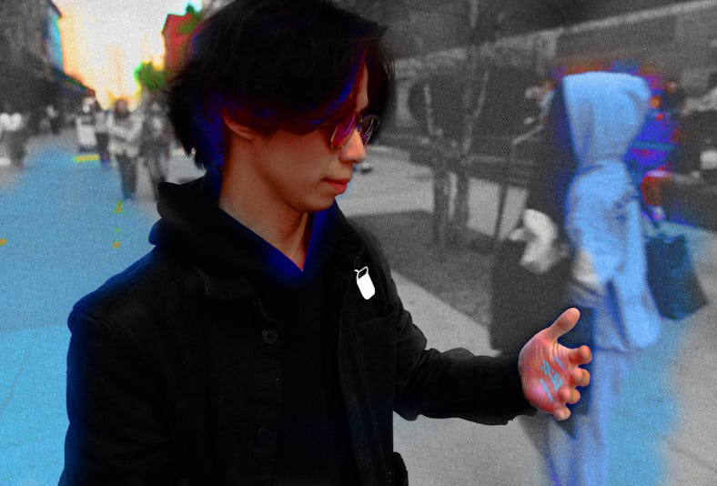 Inverse Tech Editor Raymond Wong using Humane's Ai Pin clothing-worn AI wearable on his jacket, whil...