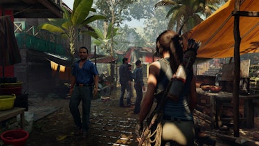 Lara Croft walks through a village.