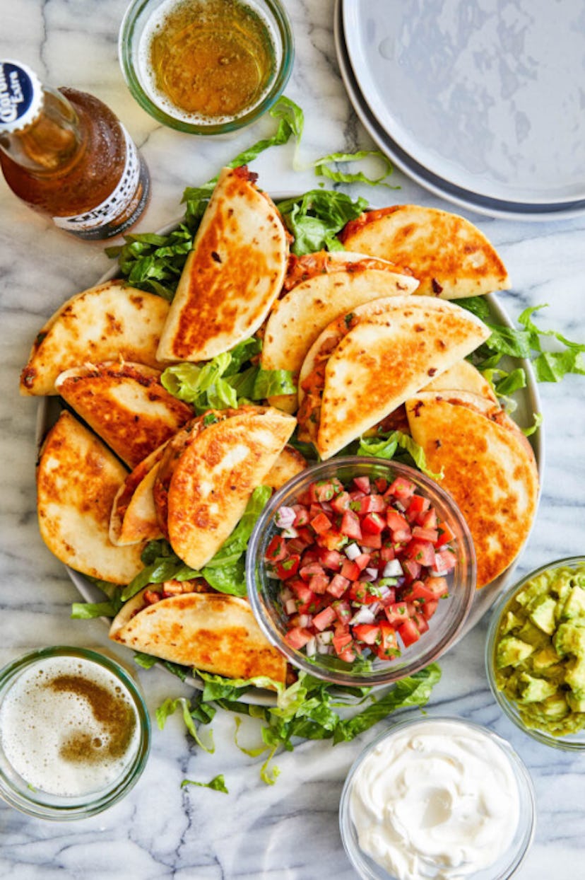 One easy toddler lunch idea is mini chicken quesadillas.