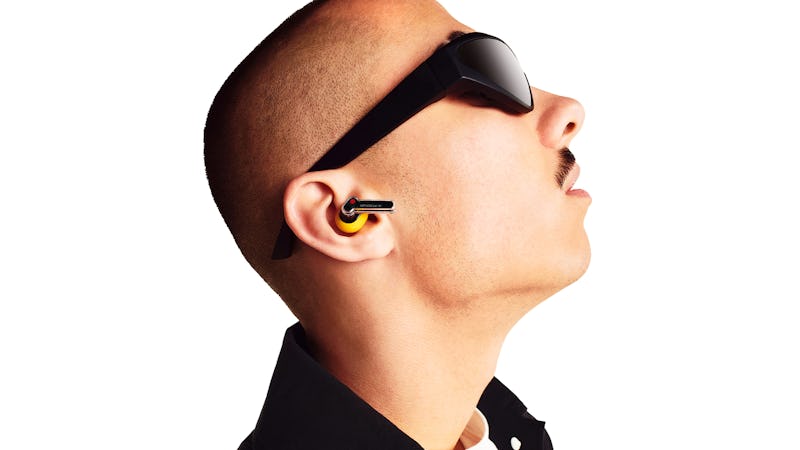 Man wearing Nothing Ear A wireless earbuds in yellow.