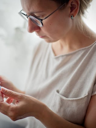 A woman looks at a pregnancy test.