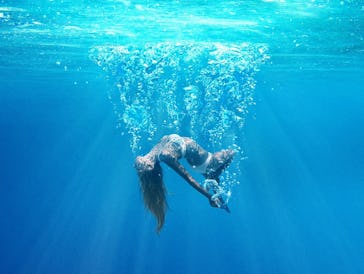 A girl sinks underwater on the poster for 'Under the Silver Lake'