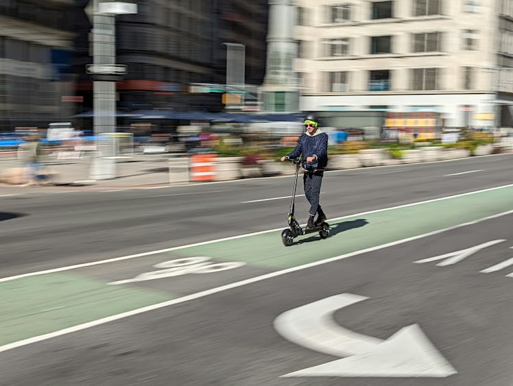 A photo of Inverse Senior Editor James Pero riding an Apollo e-scooter, taken using the Google Pixel...