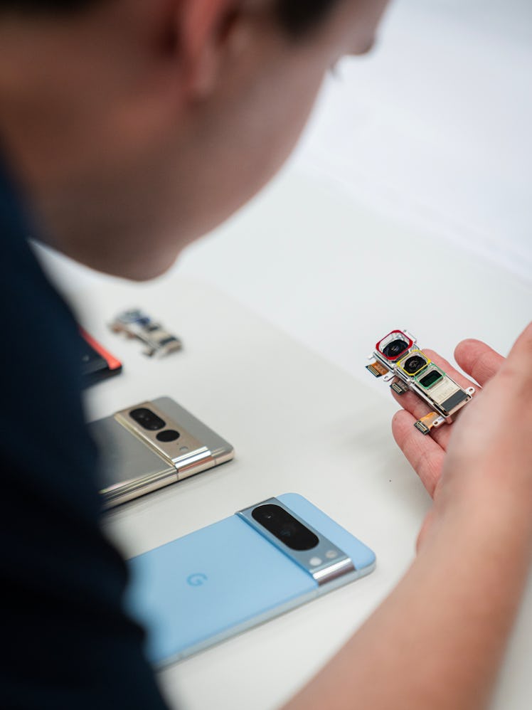 Isaac Reynolds, Group Product Manager for Google’s Pixel Camera, looking over the triple-lens camera...