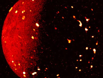 An abstract image of a bright red sphere with glowing particles scattered around it against a black ...