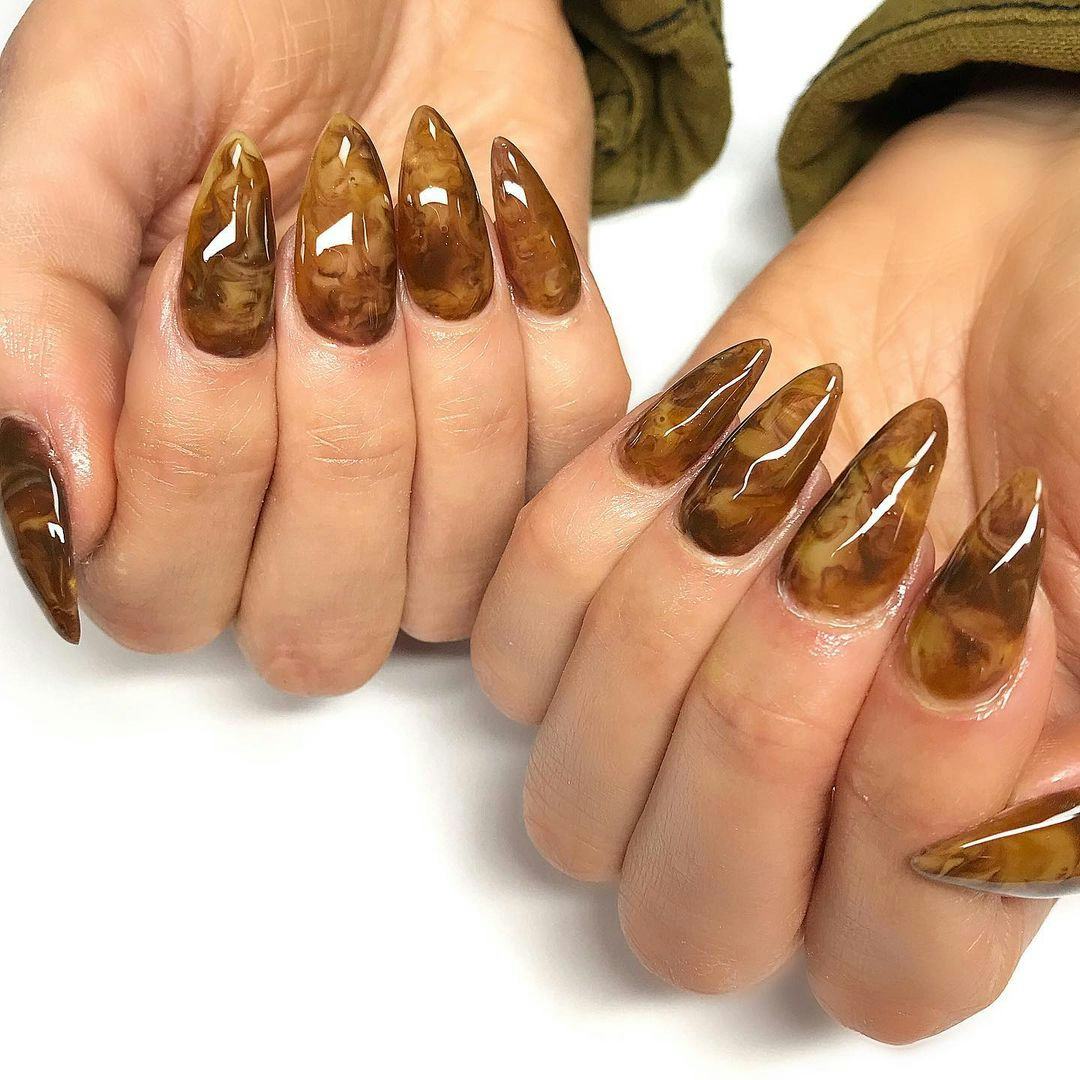 Try cozy caramel swirl nail art designs for Taurus season 2024.