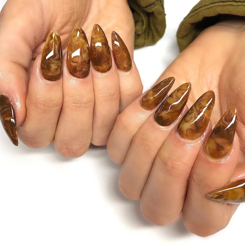 Try cozy caramel swirl nail art designs for Taurus season 2024.