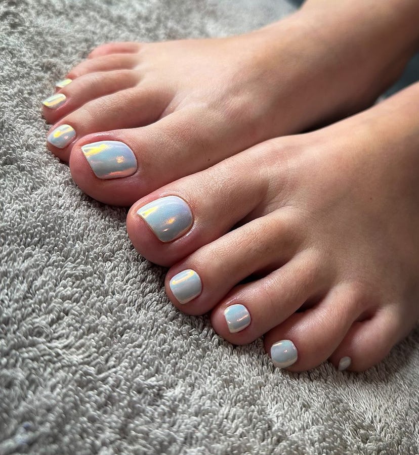 Baby blue chrome pedicures are on-trend for summer 2024.
