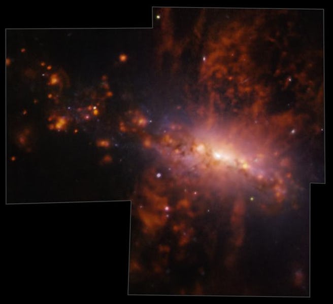 Bright spots, of different sizes, pepper the right side of a galaxy where a bright disk shines at it...