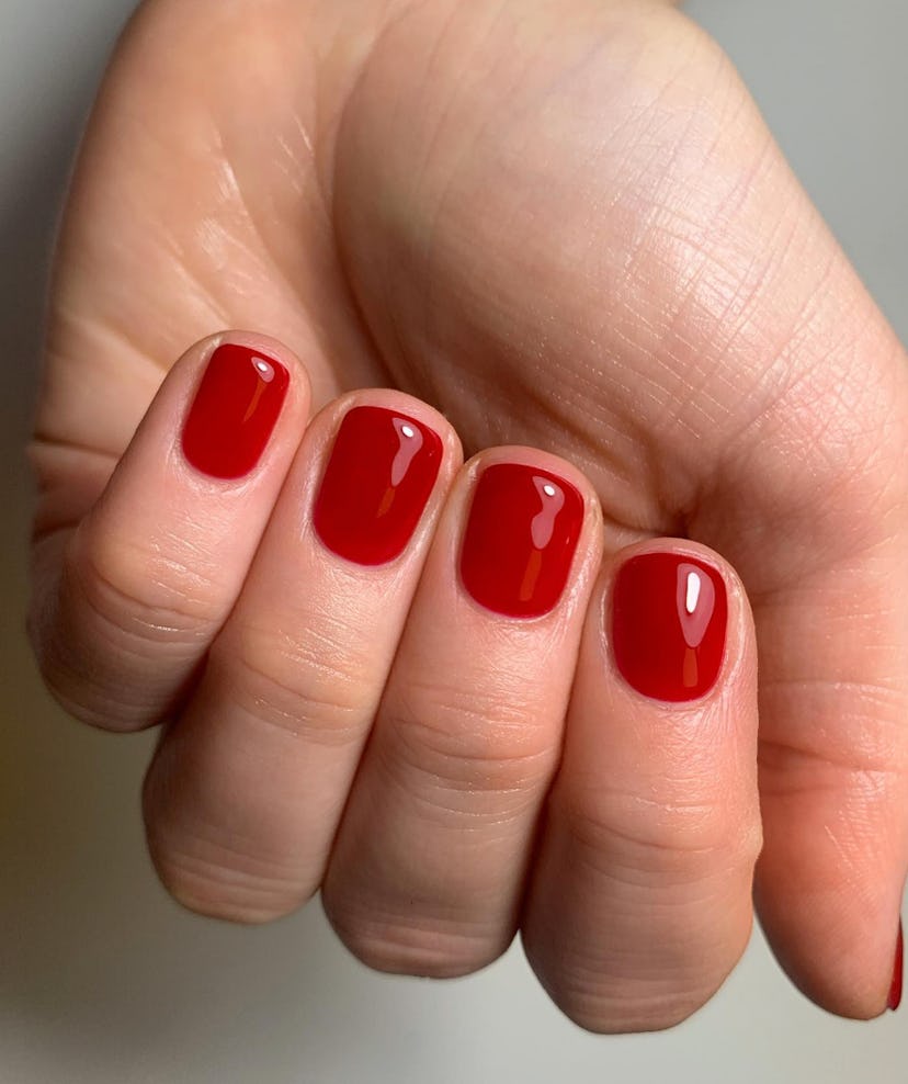 Cherry red nail polish is on-trend for summer 2024.