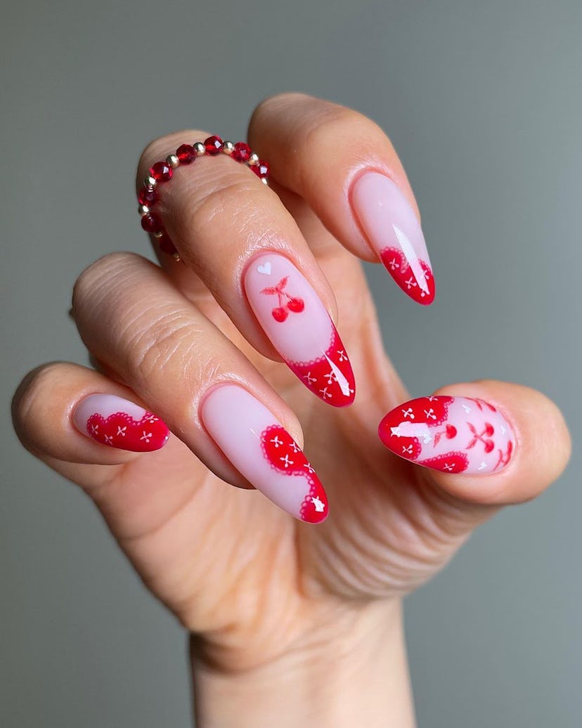 Lacy cherry printed French tip nails are on-trend.