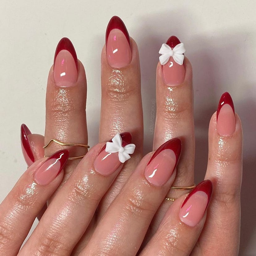 Red French tip nails with 3D bows are on-trend.