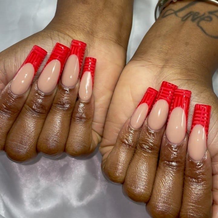Red crocodile print French tip nails are on-trend.