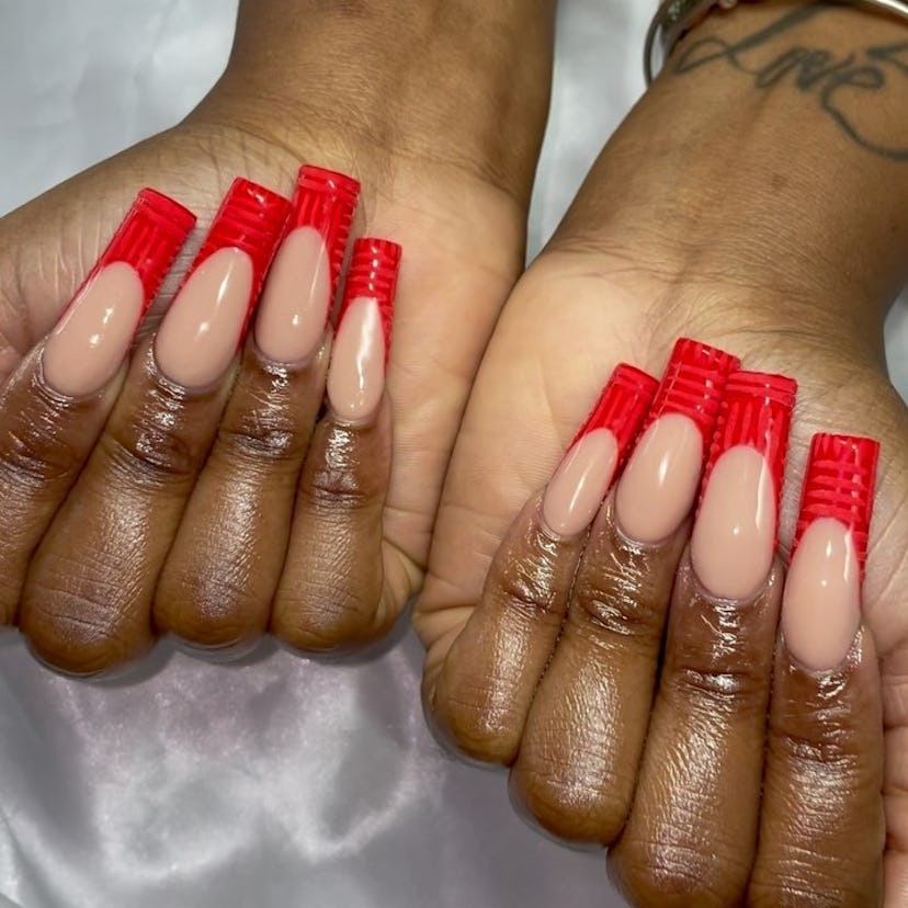 Red crocodile print French tip nails are on-trend.