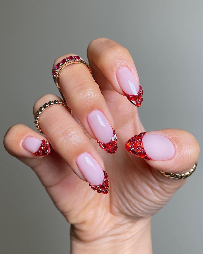 Bedazzled red French tip nails are on-trend.