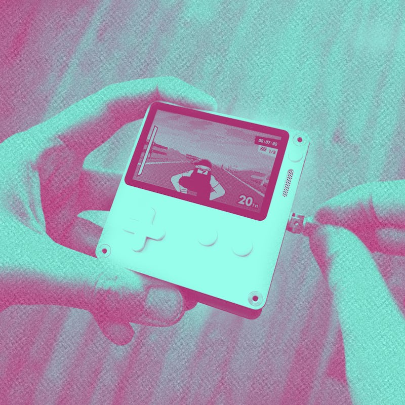 Inverse contributor Ian Carlos Campbell using the crank on the Playdate handheld to control a game.