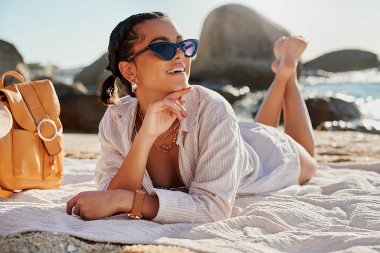 Mayıs 2024 burcunu okuduktan sonra güneş ışığının tadını çıkaran genç kadın.