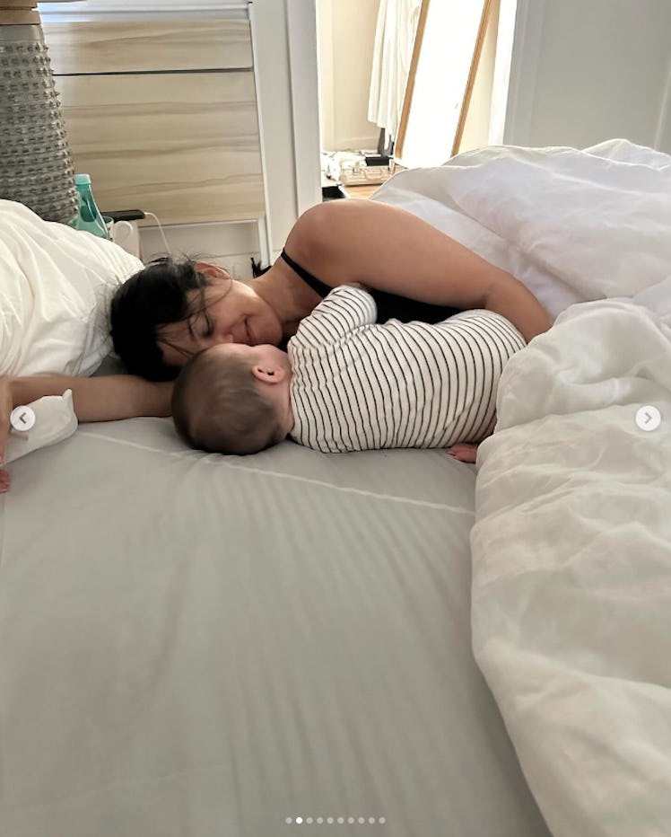 Kourtney Kardashian and Rocky snuggle in bed.