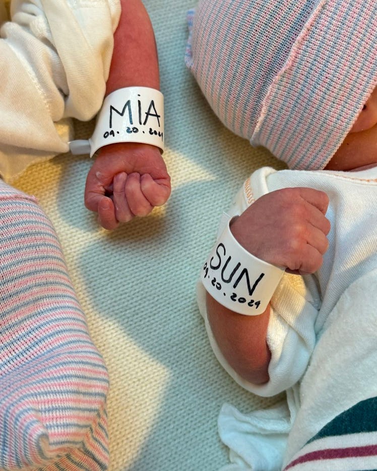 The fists of two newborn children. 