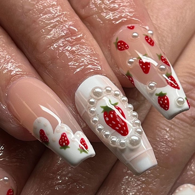 Coquette strawberry nail motifs are on-trend.