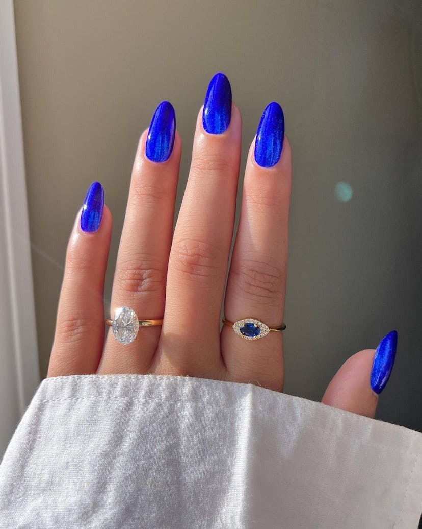 Glittering sapphire blue nails are on-trend.