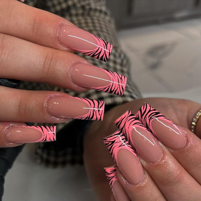 Coral zebra print French tip nails are on-trend.