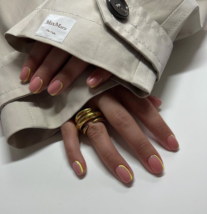 Neutral nails with neon yellow outlines are on-trend.