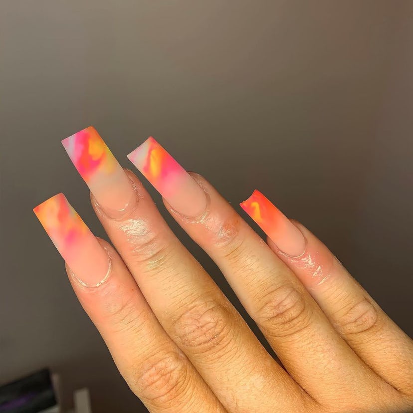 Sunset-colored watercolor French tip nails are on-trend.