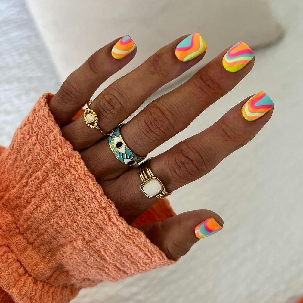 Colorful and groovy nail designs are on-trend.