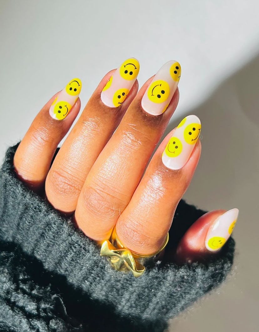Neon yellow smiley nail designs are on-trend.