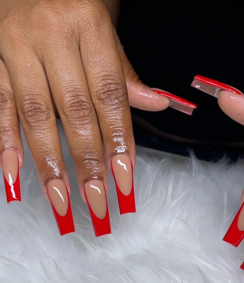 Cherry red French tip nails are on-trend.